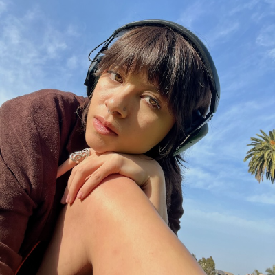 Trinity Catlin outside blue sky headphone on